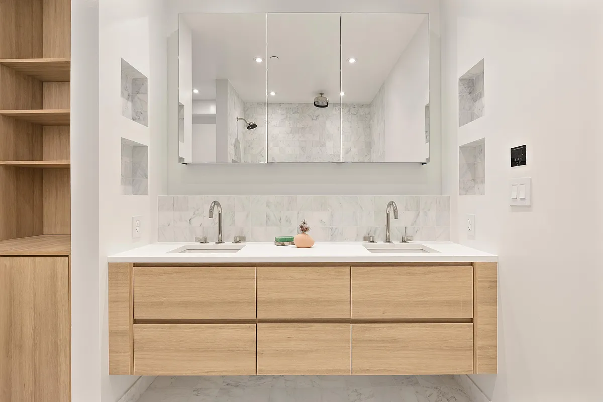 Floating white oak double vanity with two undermount sinks