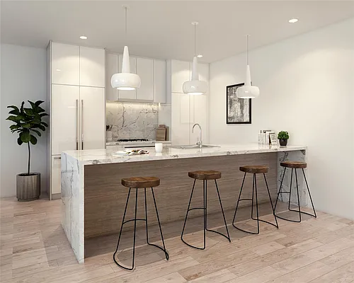 Waterfall marble island on a white oak base in a finished kitchen