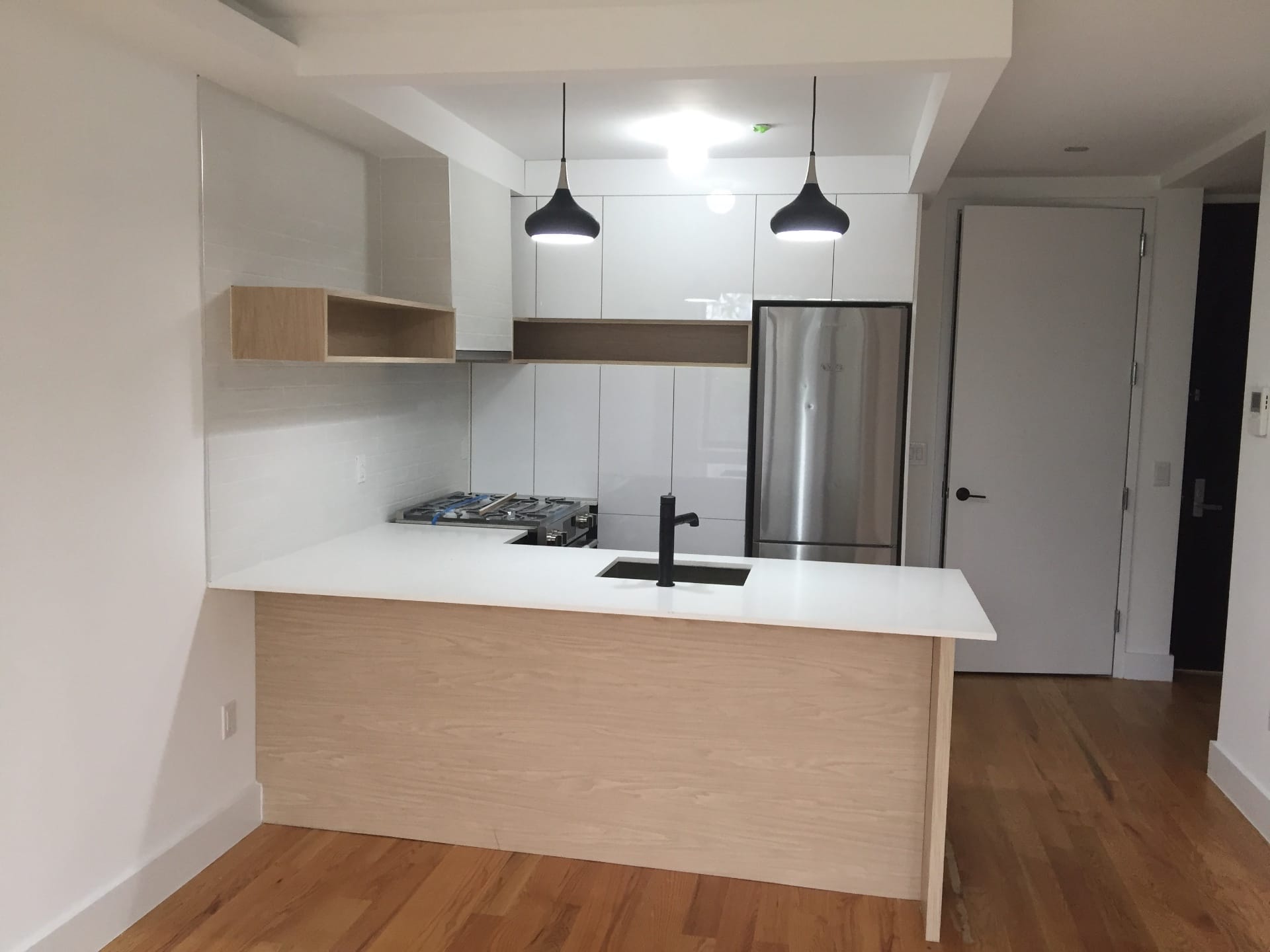 Side view, white kitchen with wood island detail — Green Cabinets NY, custom cabinetry in Long Island City, Queens