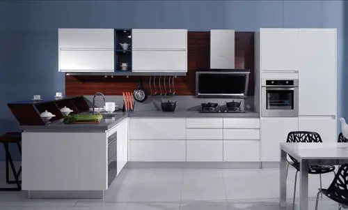 Contemporary white kitchen with blue accent wall and modern design