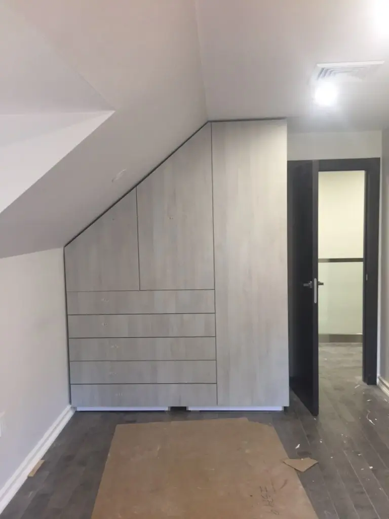 Custom closet installation with angled ceiling accommodation