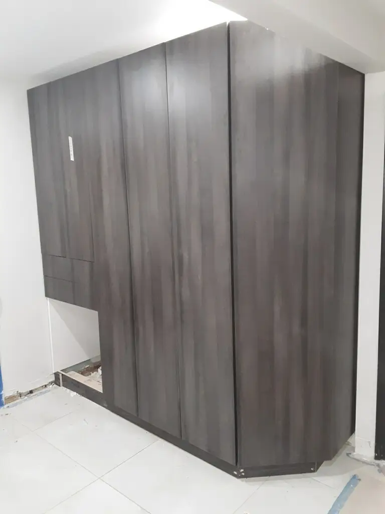 Dark wood corner wardrobe with floor-to-ceiling design