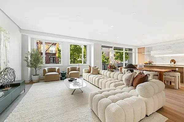 Open concept living space with completed contemporary kitchen featuring wood island and modern design