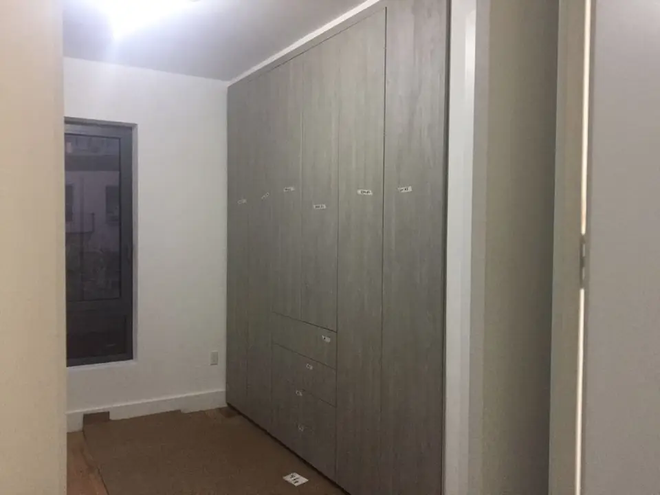 Gray wood bedroom closet with integrated drawer storage