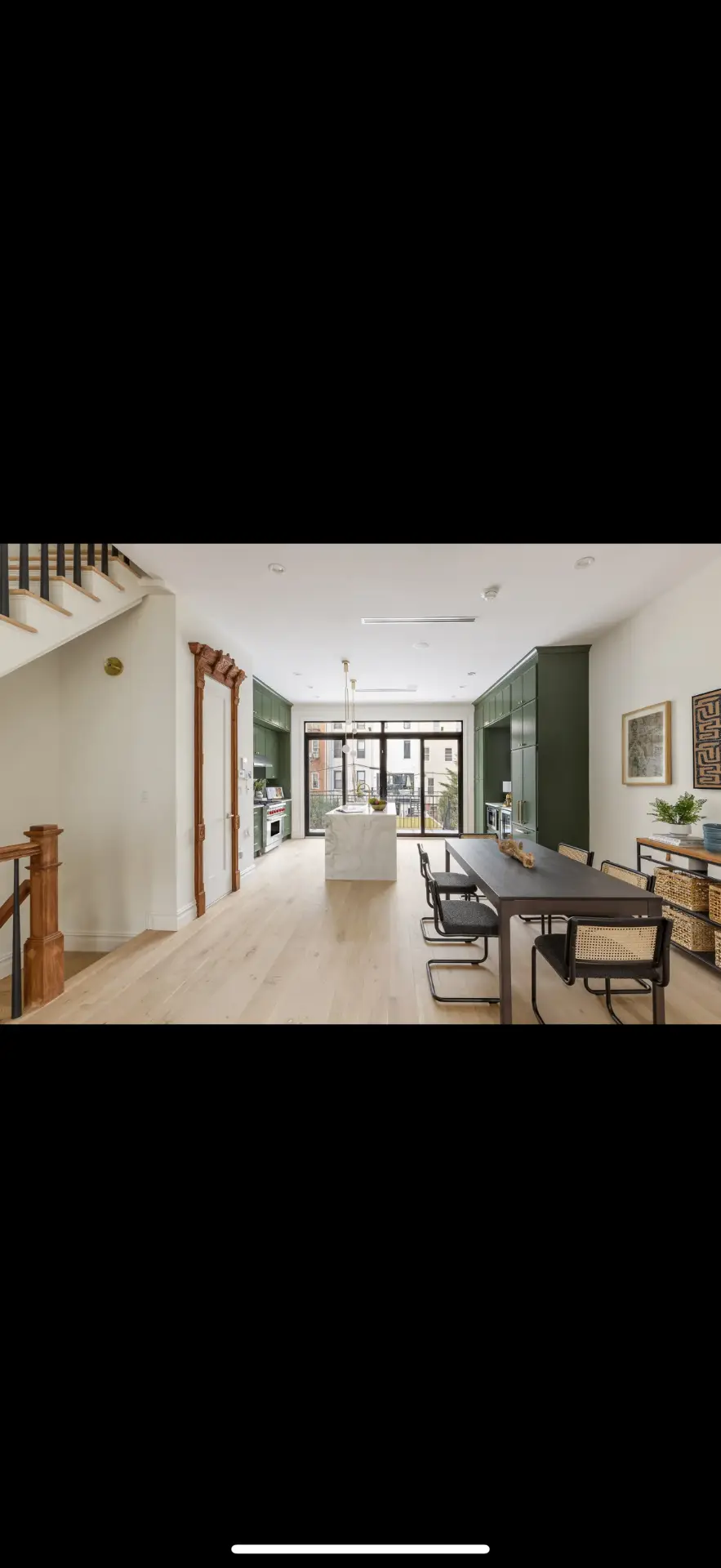 Green open concept kitchen with marble island