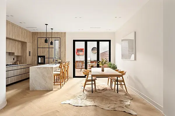 Light wood open concept kitchen with dining area and pendant lights