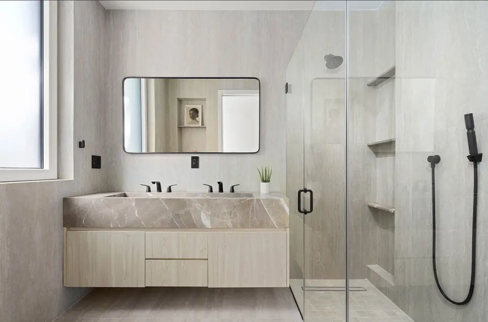 Modern bathroom with floating marble vanity and walk-in shower