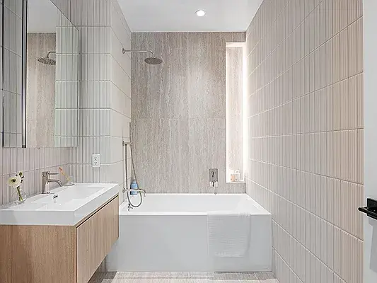 Modern bathroom with tub, glass shower, and natural wood floating vanity