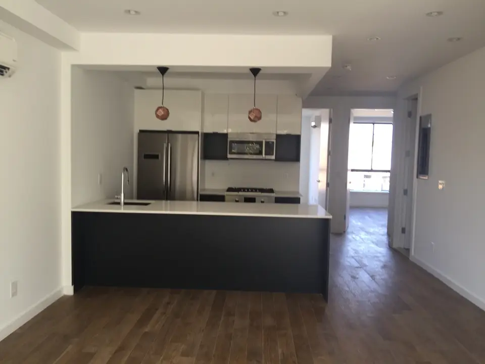 Modern kitchen with dark island and pendant lighting