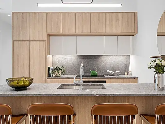 Modern kitchen wood cabinets close-up with gray marble countertops