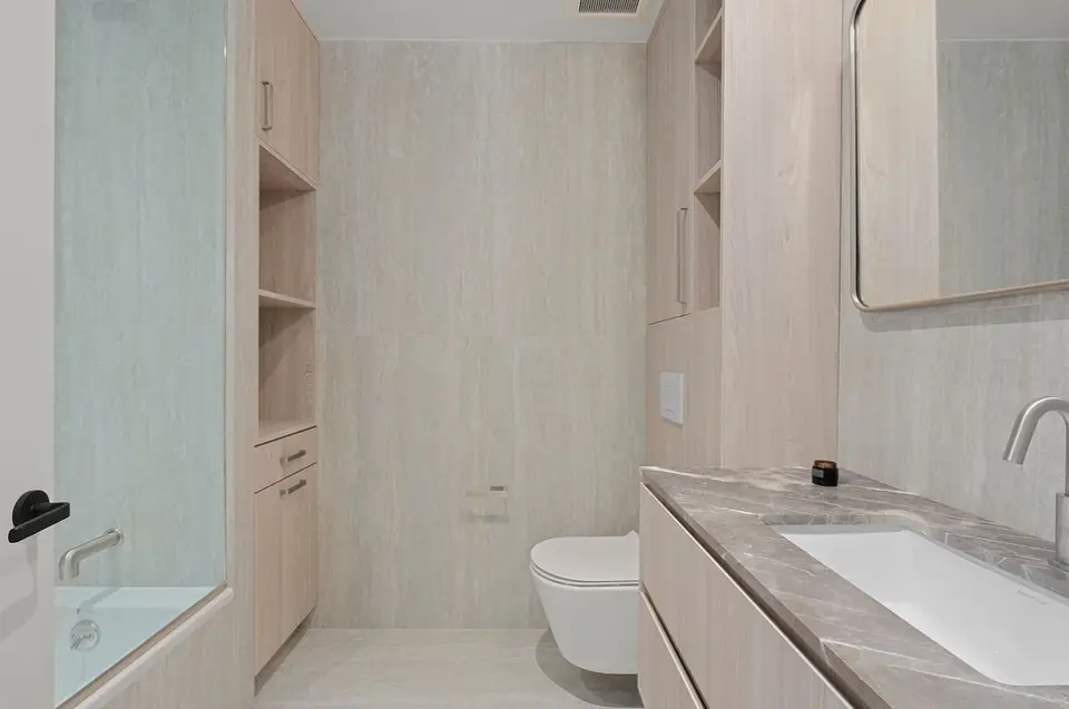 Modern powder room with marble countertop and storage