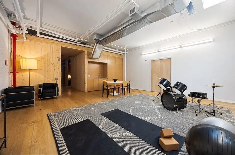 Modern studio apartment with custom wood cabinetry and dining area