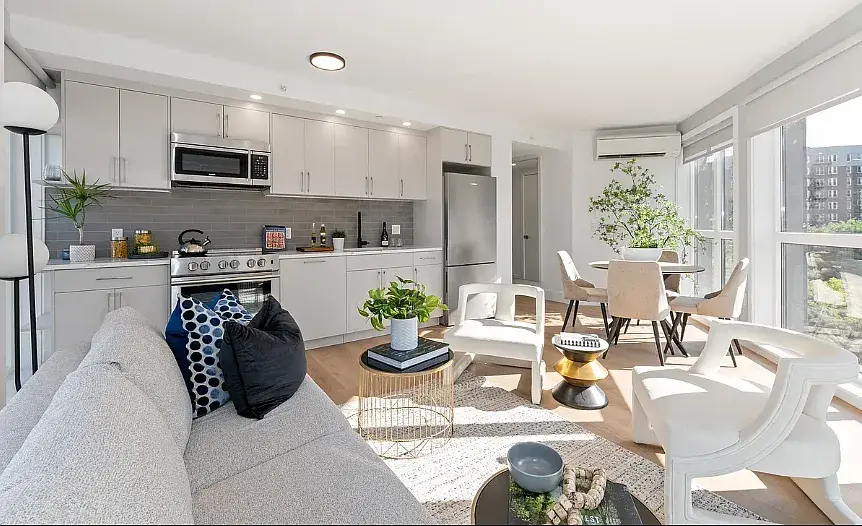 Modern white kitchen with open concept living and dining area