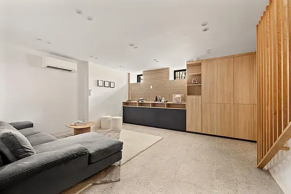 Modern wood kitchen with dark base cabinets and open concept living