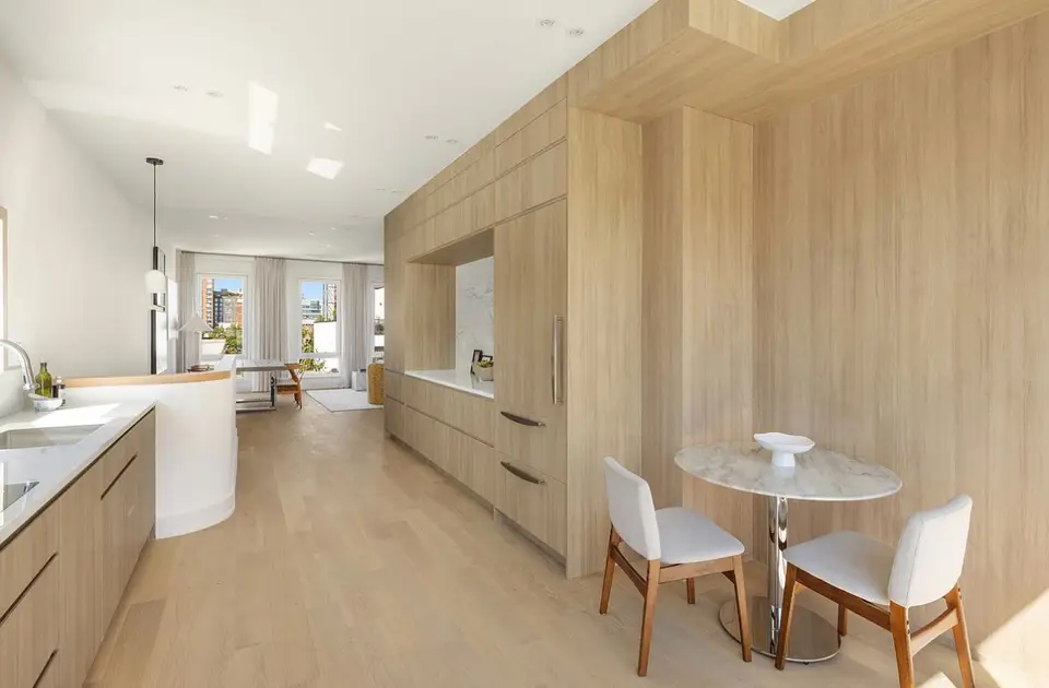 Natural wood open concept kitchen with dining area