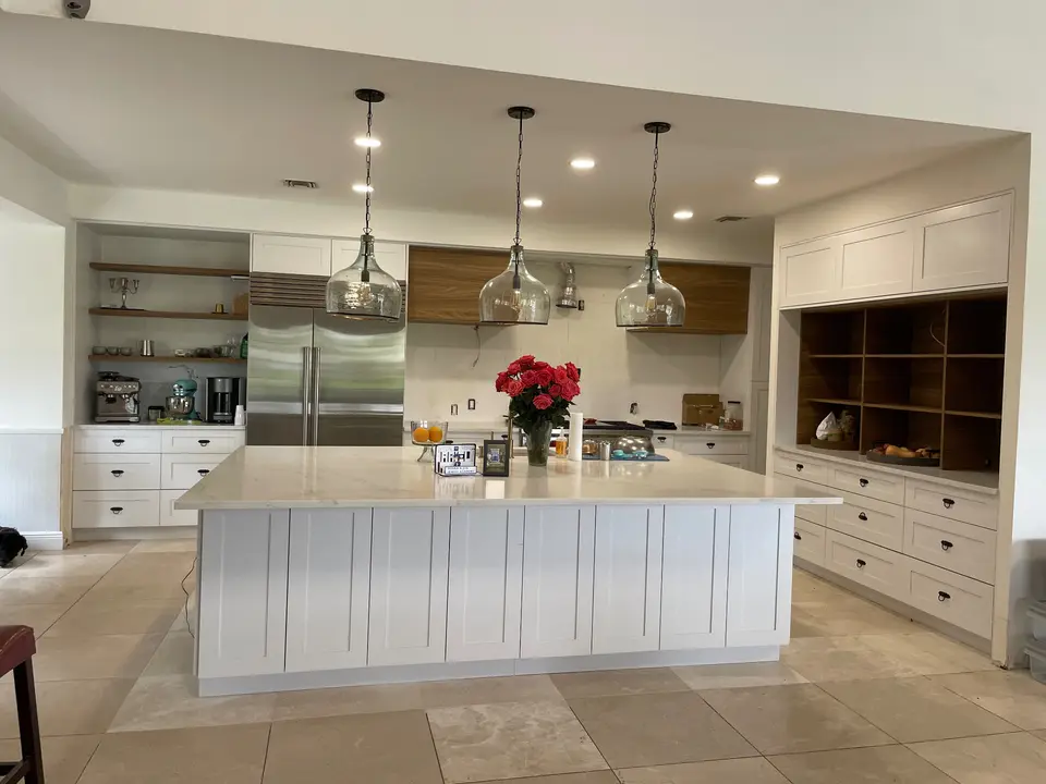 White traditional kitchen with glass pendant lights and open shelving