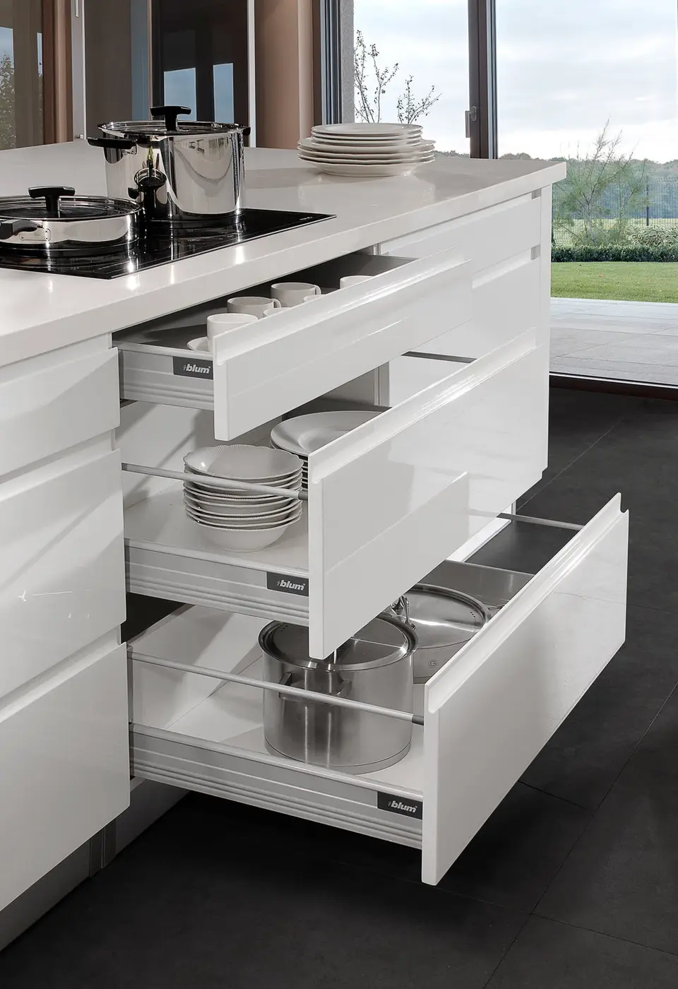 White kitchen island with organized Blum drawer system